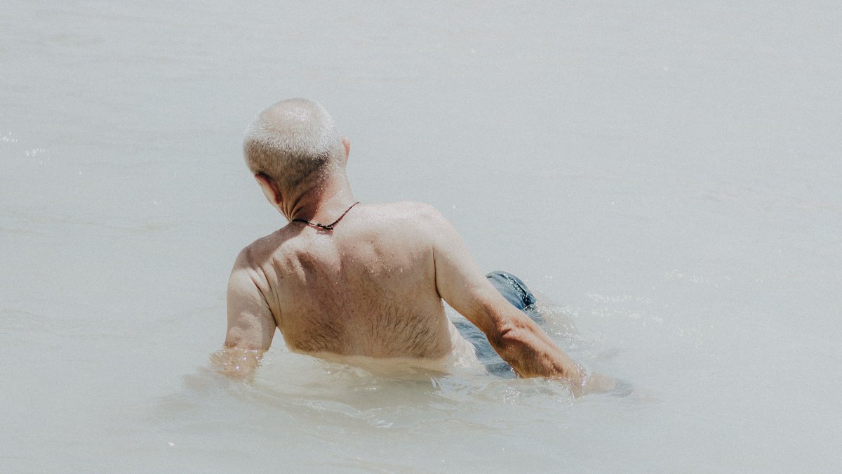 A senior man enjoying a relaxing time in the water at Canoa Quebrada, Brazil.