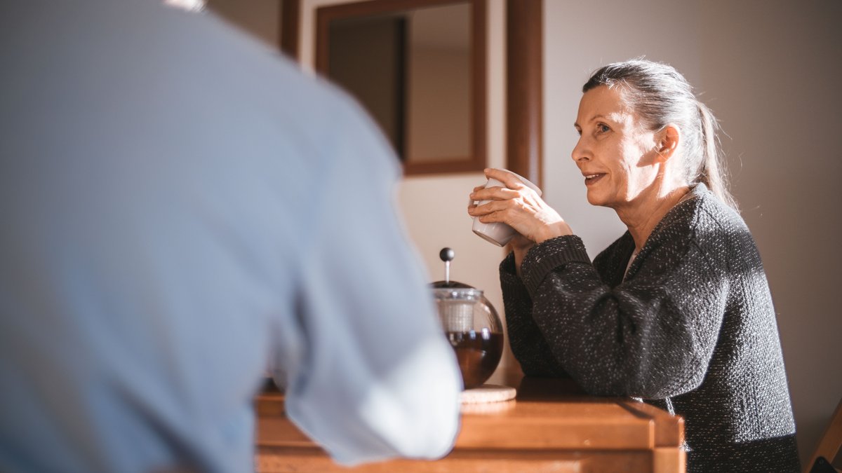 Cheerful senior couple enjoying coffee together in a cozy home setting.
