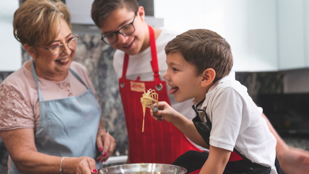A joyful family moment baking in the kitchen with a grandmother and grandsons, enjoying quality time.
