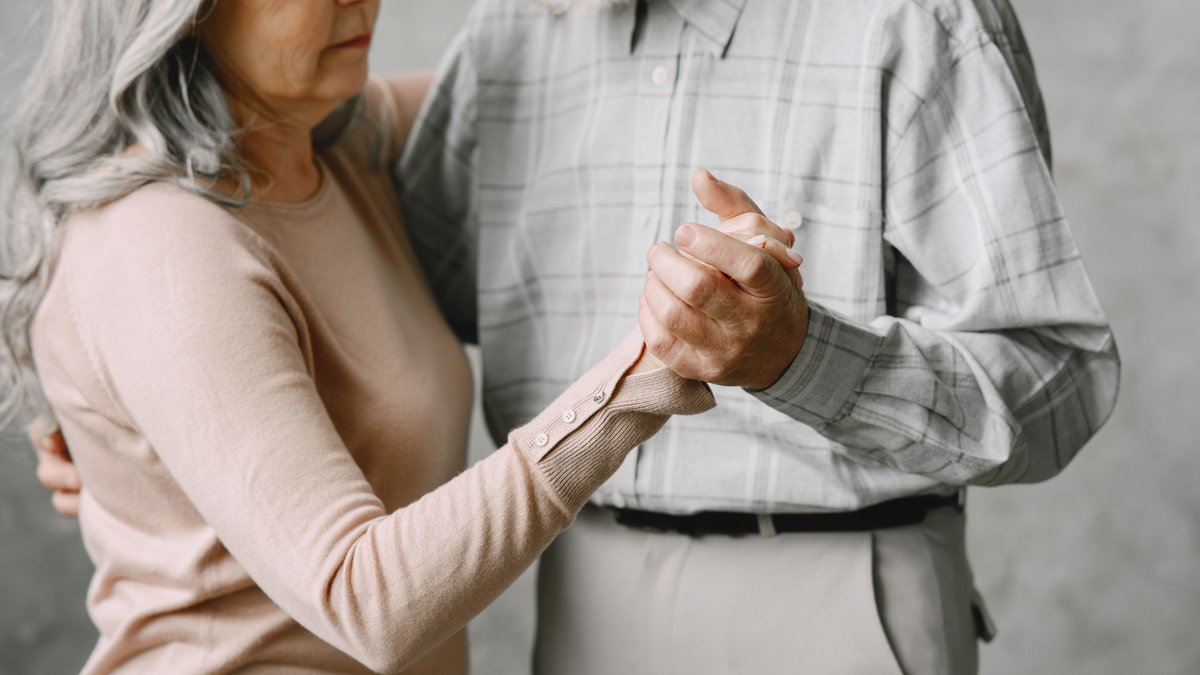 Senior couple gracefully dancing together, radiating love and connection.