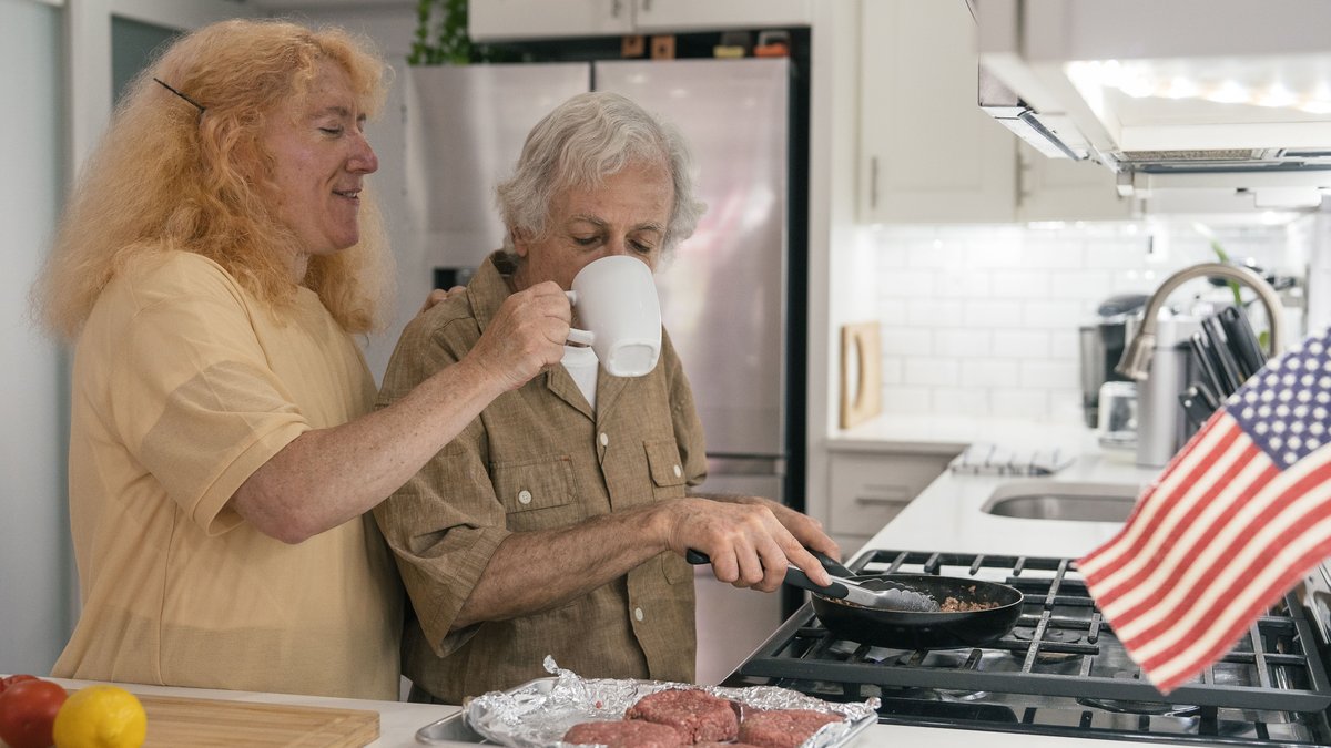 Senior couple enjoying cooking together at home, a heartwarming scene of togetherness and love.